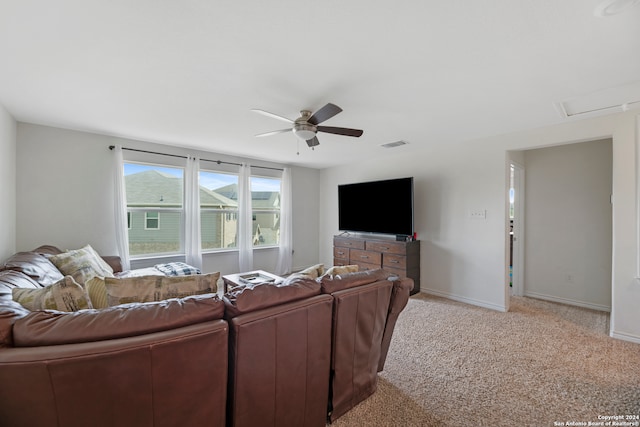 carpeted living room with ceiling fan