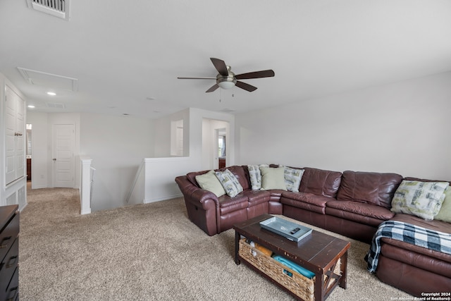 living room with ceiling fan and light colored carpet