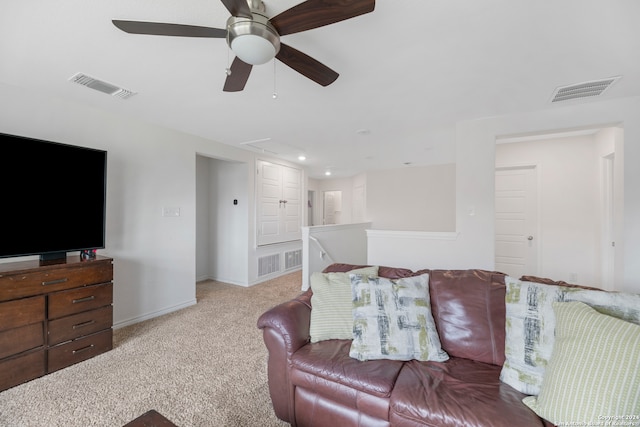 carpeted living room with ceiling fan