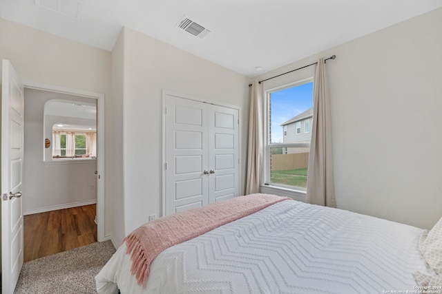 bedroom featuring multiple windows, a closet, and carpet flooring