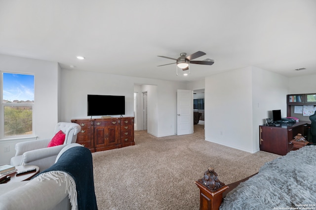 living room with ceiling fan and light colored carpet