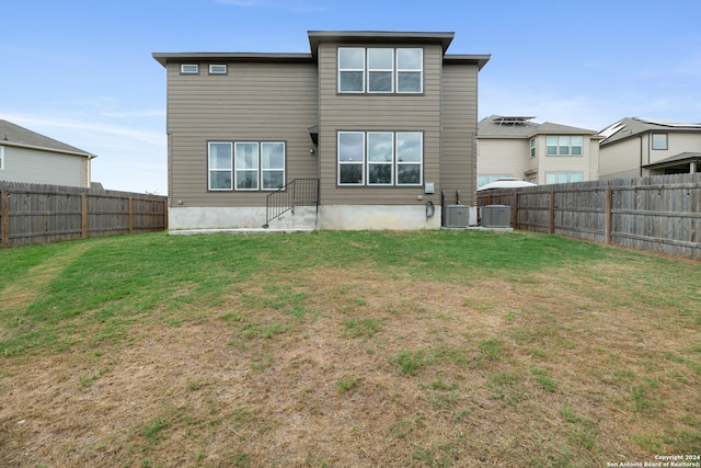 rear view of house featuring a yard