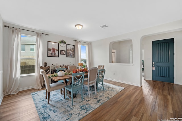 dining room with hardwood / wood-style floors and a healthy amount of sunlight