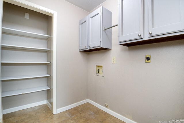 laundry room featuring light tile patterned flooring, electric dryer hookup, cabinets, and hookup for a washing machine