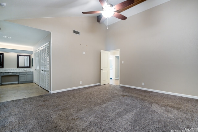 interior space with light carpet, high vaulted ceiling, and ceiling fan