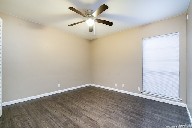 empty room with ceiling fan and dark hardwood / wood-style flooring