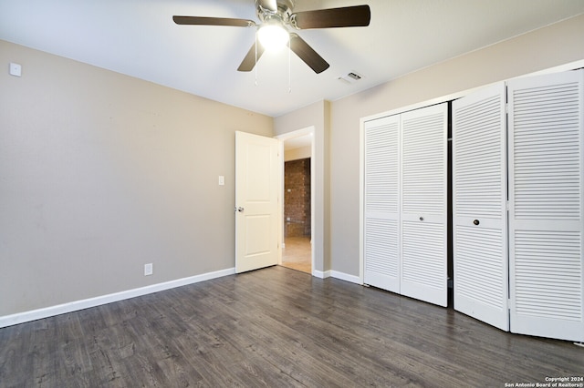 unfurnished bedroom featuring a closet, ceiling fan, and dark hardwood / wood-style floors