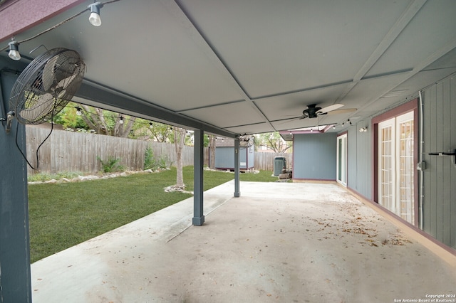 view of patio featuring ceiling fan, a shed, and cooling unit