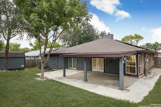 rear view of house with a yard, a patio area, and french doors