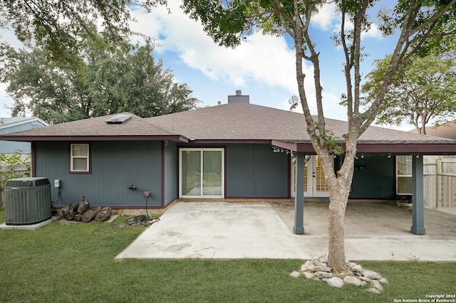 rear view of property with a yard, a patio, and cooling unit