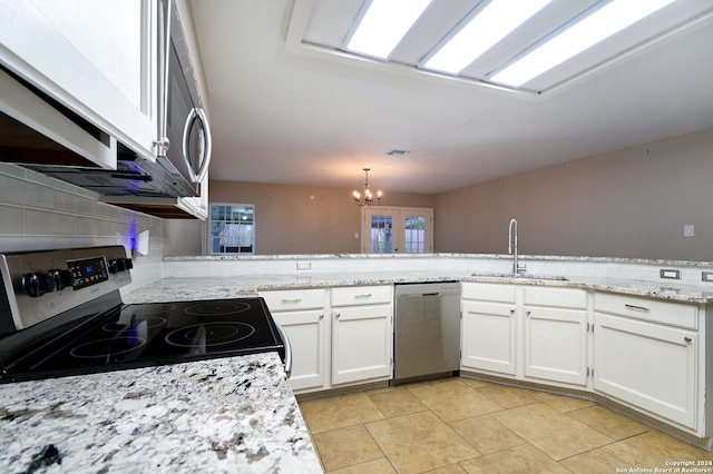 kitchen with sink, appliances with stainless steel finishes, white cabinetry, and tasteful backsplash