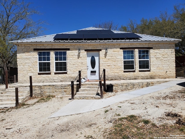 view of front facade with solar panels