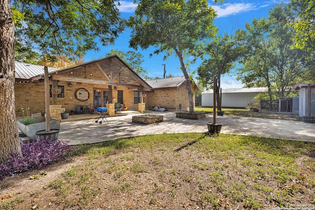 back of property featuring a yard and a patio area