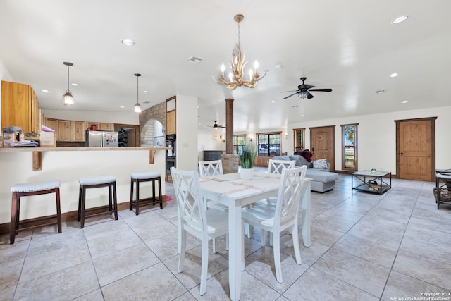 dining room featuring light tile patterned flooring and ceiling fan with notable chandelier