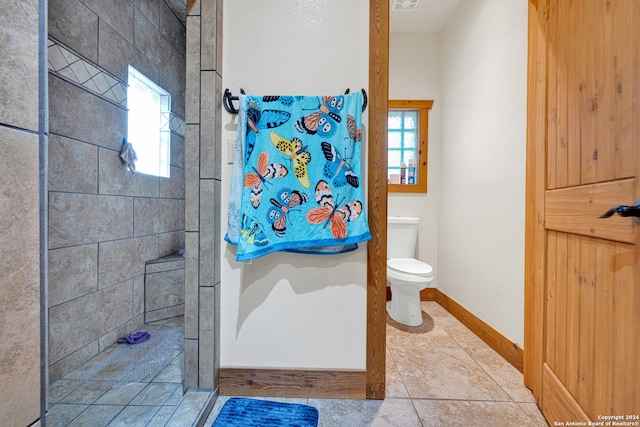 bathroom featuring toilet and tile patterned flooring