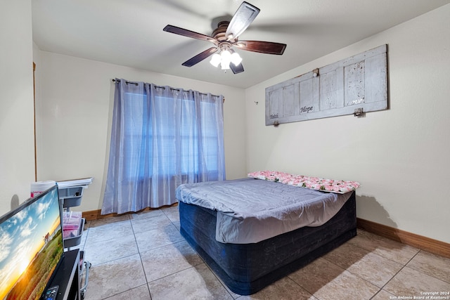 bedroom featuring light tile patterned floors and ceiling fan