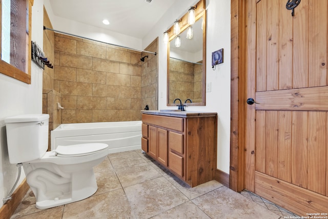 full bathroom featuring vanity, toilet, tile patterned floors, and tiled shower / bath