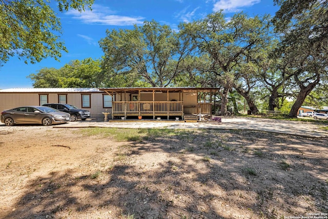 rear view of house featuring covered porch