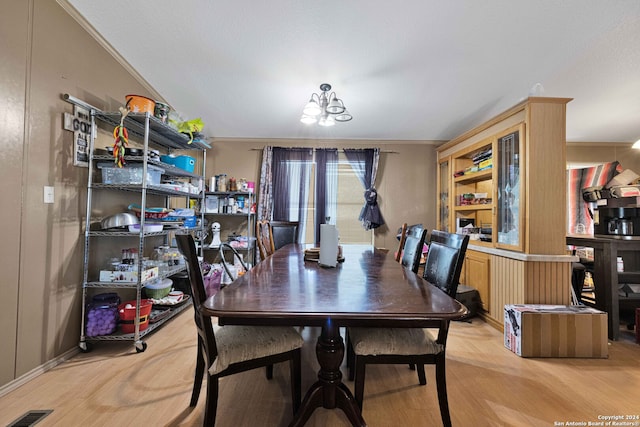 dining space featuring light hardwood / wood-style floors and ornamental molding