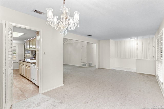 unfurnished dining area with light carpet and a textured ceiling