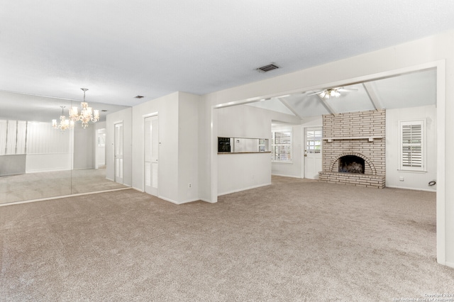 unfurnished living room featuring vaulted ceiling with beams, light colored carpet, ceiling fan with notable chandelier, and a fireplace