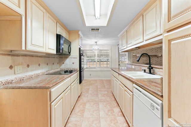 kitchen featuring light tile patterned flooring, black appliances, sink, and decorative backsplash