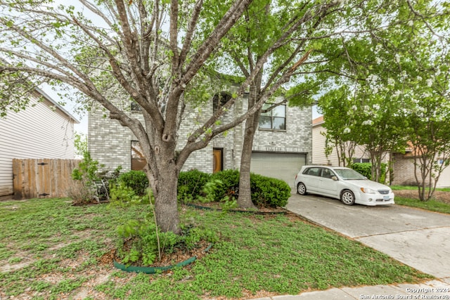 view of front of house featuring a front yard and a garage