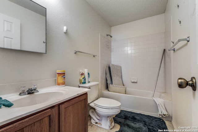 full bathroom with vanity, toilet, tiled shower / bath combo, and a textured ceiling