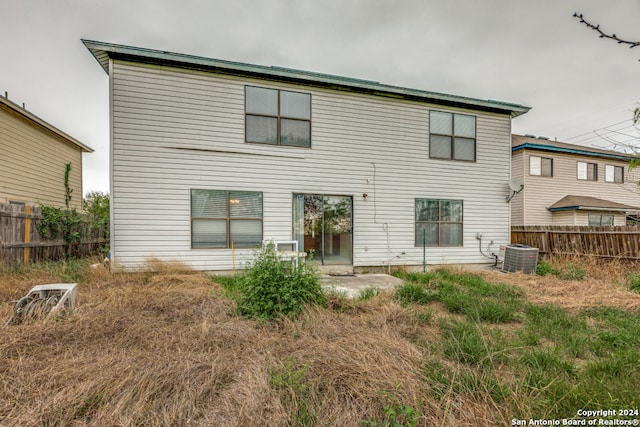 rear view of property with central air condition unit