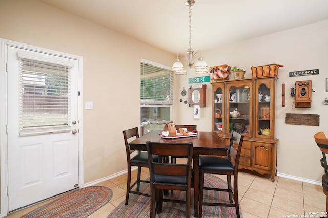 dining room featuring a notable chandelier and light tile patterned floors