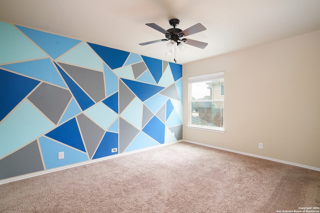 empty room featuring carpet floors and ceiling fan