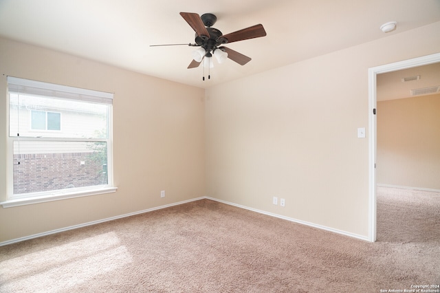 spare room with carpet floors and ceiling fan