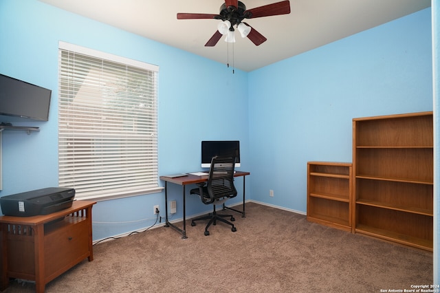 carpeted home office with ceiling fan