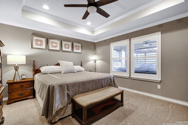 bedroom featuring crown molding, a raised ceiling, carpet, and ceiling fan