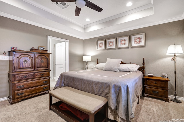 carpeted bedroom with ornamental molding, a raised ceiling, and ceiling fan