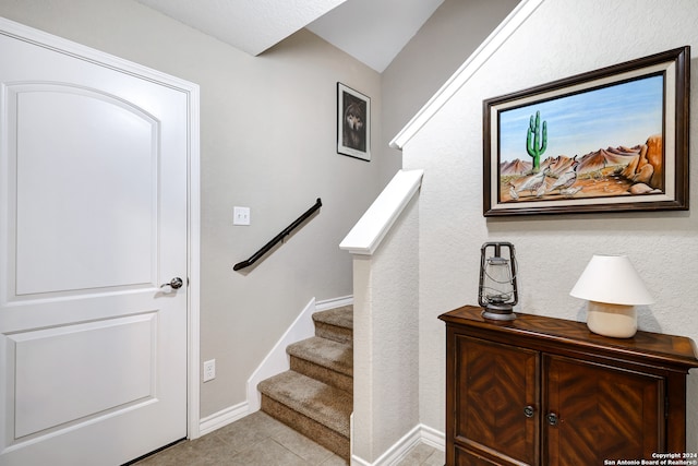 stairway featuring tile patterned floors