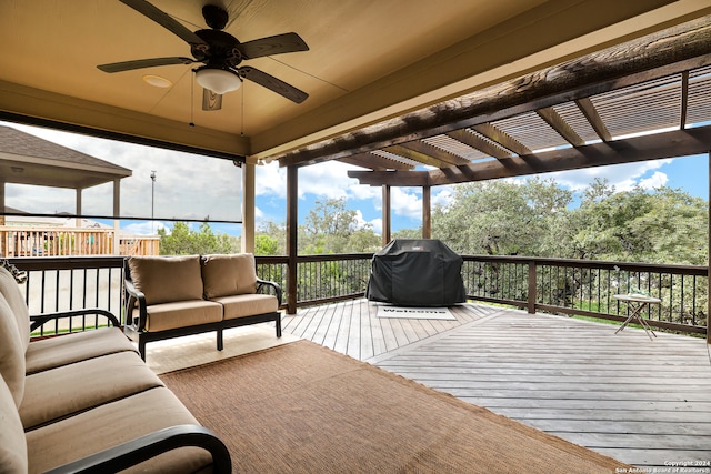 deck featuring an outdoor hangout area, ceiling fan, grilling area, and a pergola