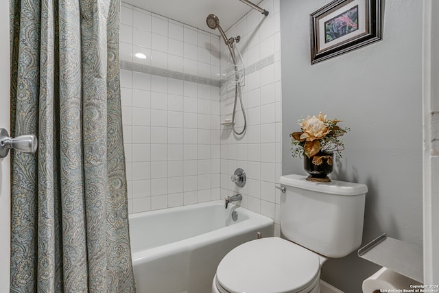 bathroom with shower / bath combination with curtain and toilet