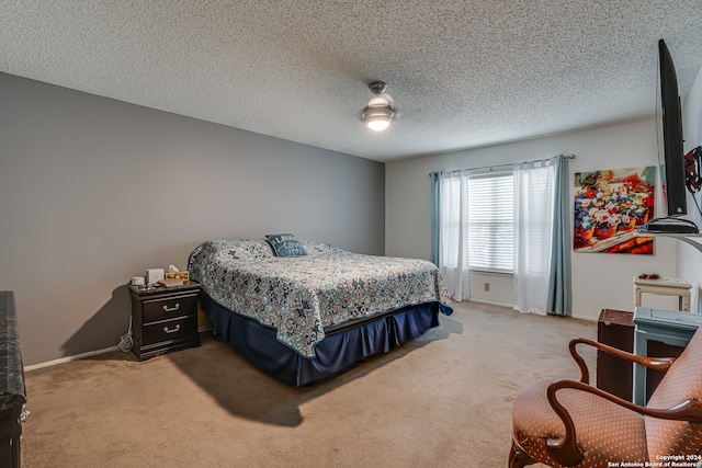 bedroom with a textured ceiling, carpet, and ceiling fan