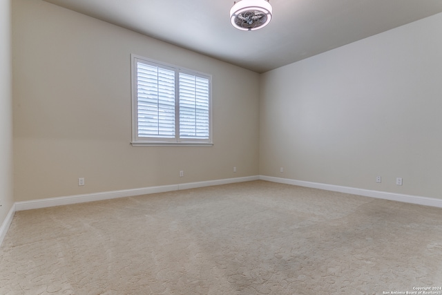 spare room with light colored carpet