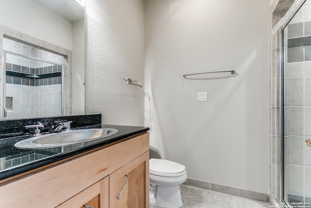 bathroom with vanity, an enclosed shower, tile patterned floors, and toilet