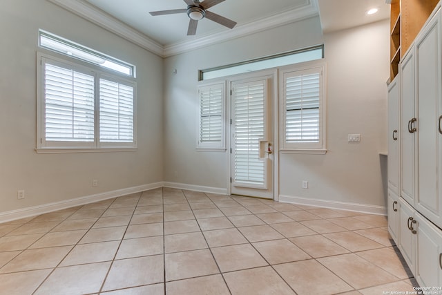 interior space with crown molding, ceiling fan, and light tile patterned floors