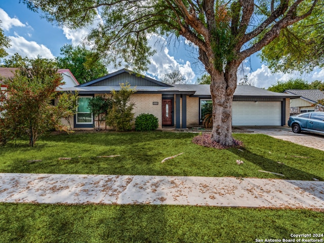 ranch-style house with a garage and a front yard