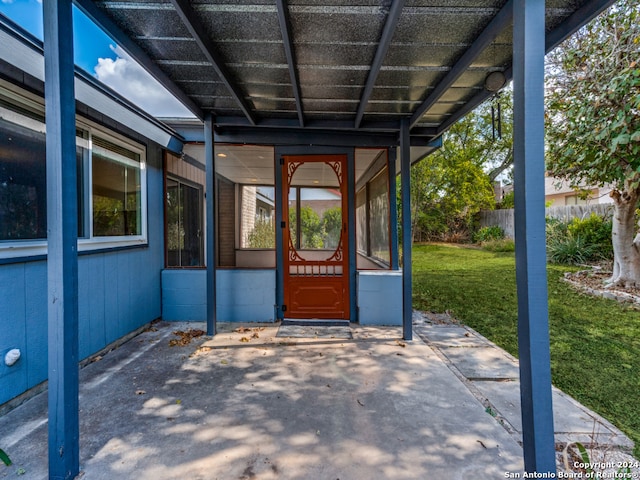 doorway to property featuring a yard and a patio