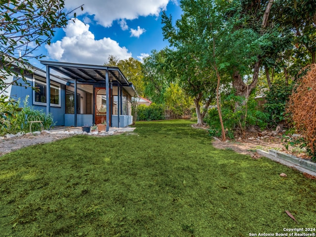 view of yard featuring a sunroom