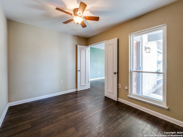 spare room with ceiling fan and dark hardwood / wood-style flooring