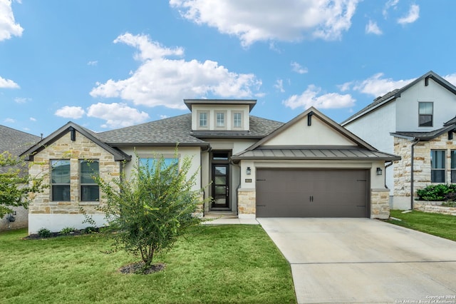 view of front of house with a front yard and a garage