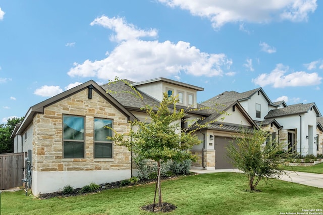 view of front of property with a front lawn and a garage