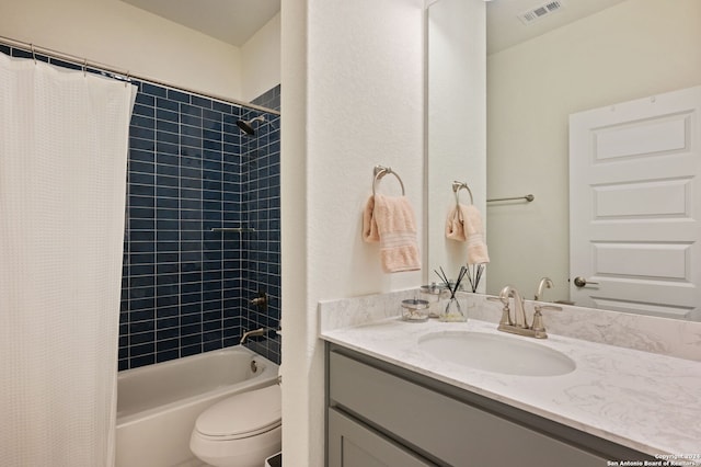 full bathroom featuring toilet, shower / bath combo, and vanity