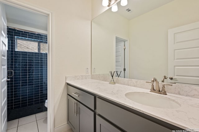 bathroom with vanity, toilet, a shower with shower door, and tile patterned flooring